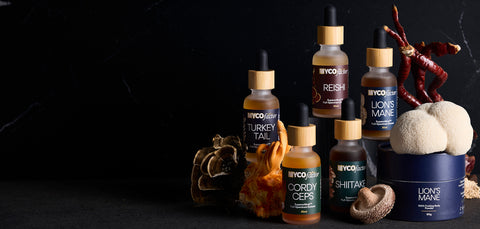 Collection of MYCOfactor mushroom wellness products on a dark background